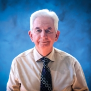 Cameron Carter, headshot with blue background