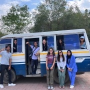Medical students pose in and around a van during a clinical trip in India.