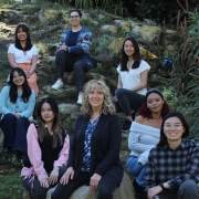 10 students with with Lisa Flanagan on a hillside.