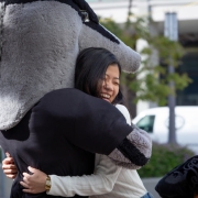 Grad studies student hugging anteater