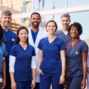 Group of medical professionals posing outside.