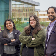 Three graduate students standing next to Gerard Slobogean