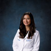 Headshot of Nellie Nafissi in whitecoat