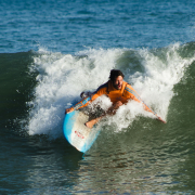 Surfer riding a powerful wave with skill and focus at sea.
