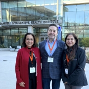 rs. Geeta Grover, Greg Buchert and Pooja Bhalla in front of the College of Health Sciences building