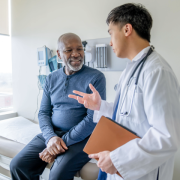 black elderly man in a doctor's office physician speaking to him