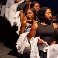 As students walk in, carrying their white coats in their arms, one student blows a kiss.