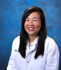 Headshot of Michelle Bardis, Radiology resident, in white coat