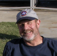 Former Professor James Hall outdoors wearing a baseball cap