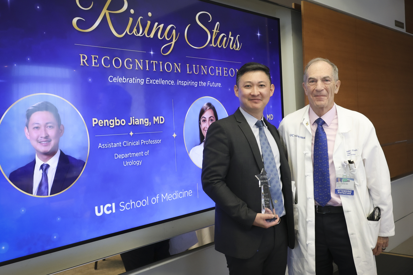 Jiang holds his award as he stands with Clayman