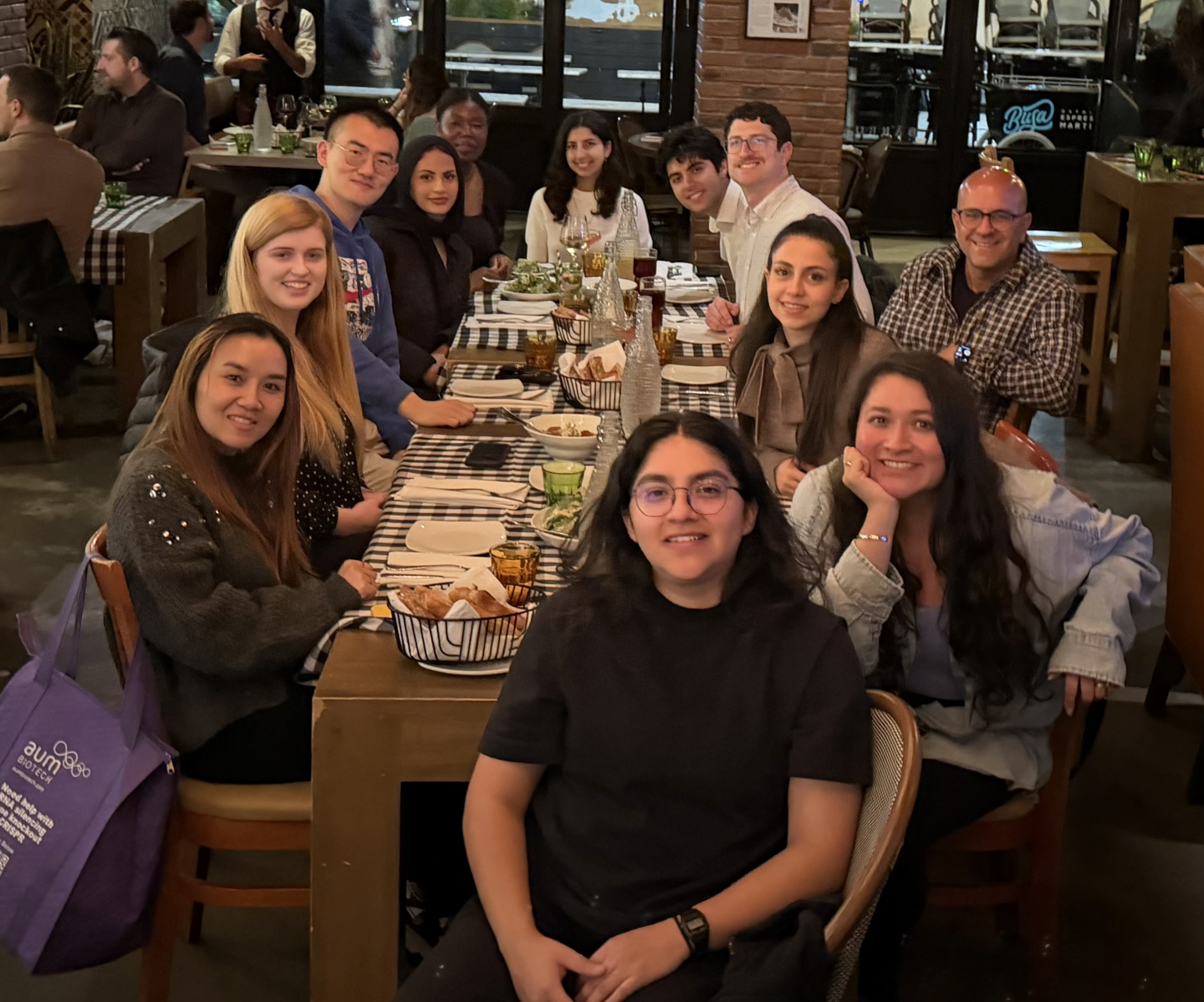 Twelve people seated around a large dining table.