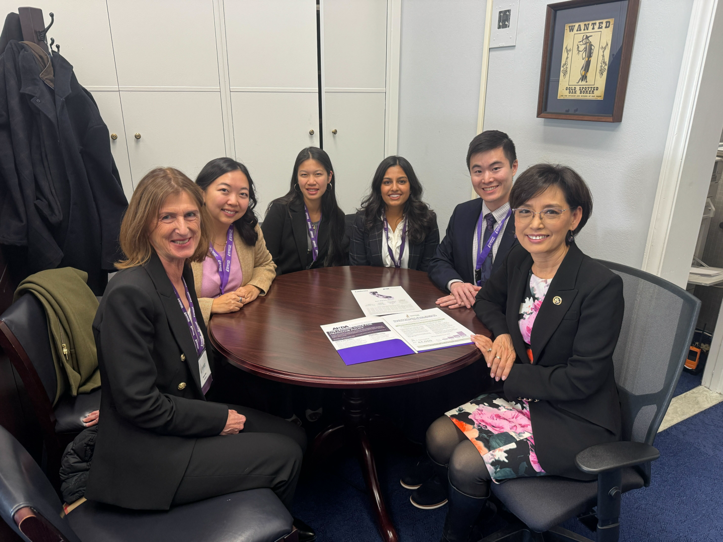 Nan Cheng, Young Kim and four others sit around a table together.
