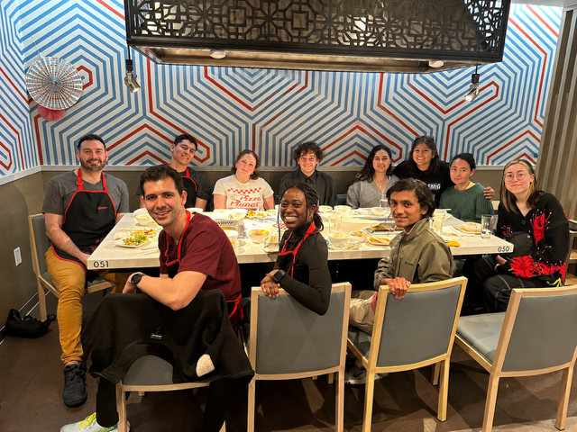 Rivera at a restaurant, with 10 other students seated at the table with him.