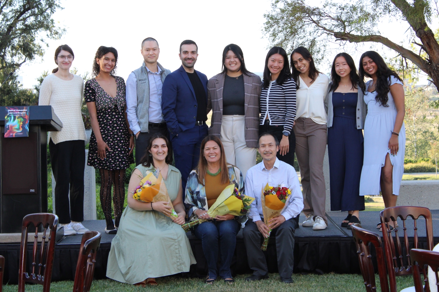 Twelve people standing together outside