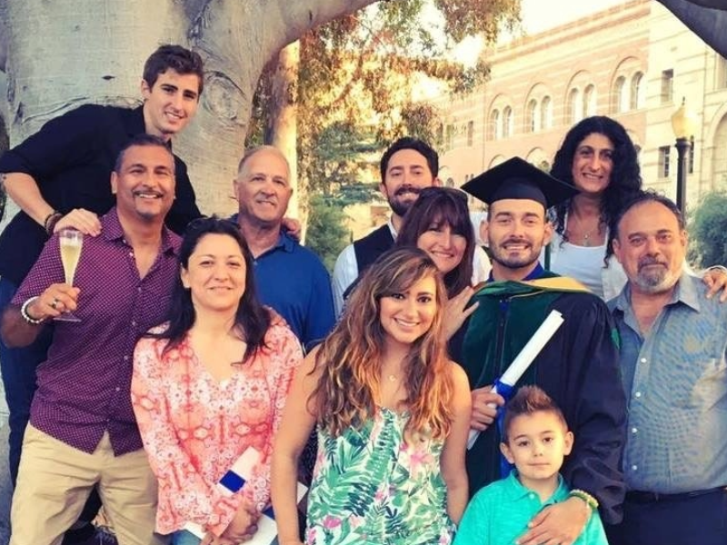 Ronald Rivera at graduation with 10 family members surrounding him