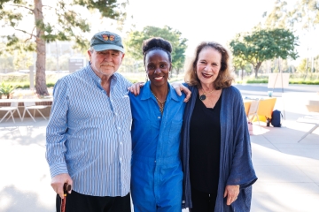 Dr. Meyskens, Ama Wray and Linda Meyskens stand together outside