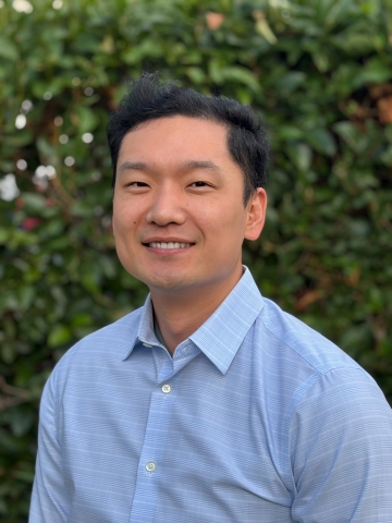Professional headshot of Kevin Tang