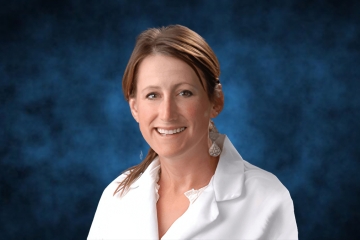 a profile headshot of Katherine McCartney in white lab coat
