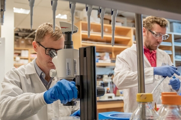 People in lab using equipment.