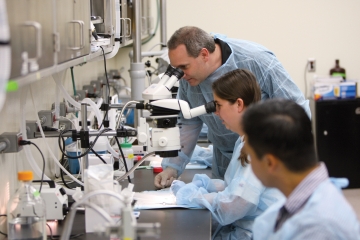 Students doing research with microscopes.